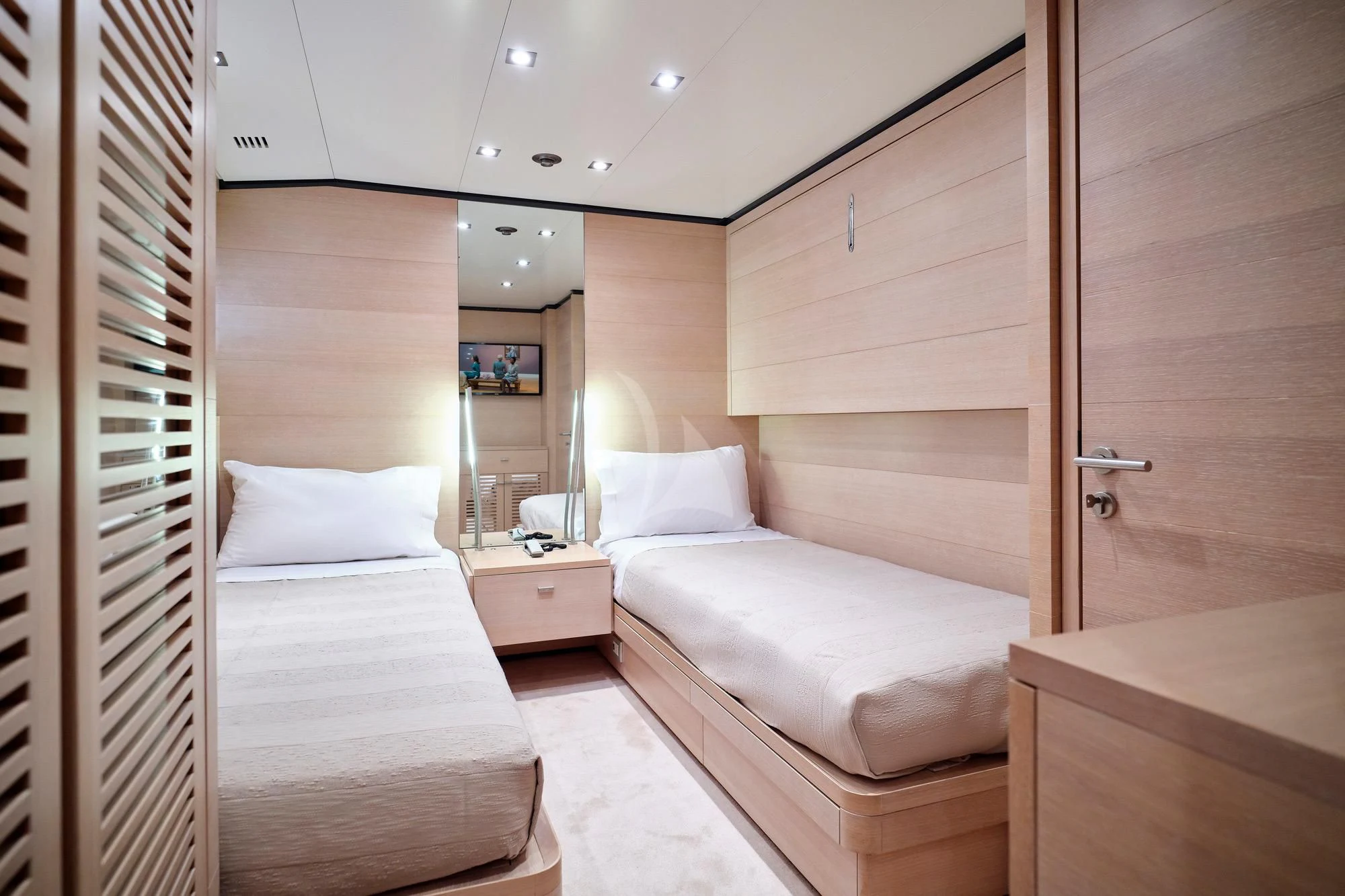a room with a bed and a mirror aboard AMICI PER SEMPRE Yacht for Charter