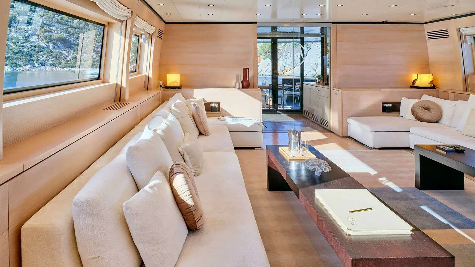 a large living room with a large window aboard AMICI PER SEMPRE Yacht for Charter