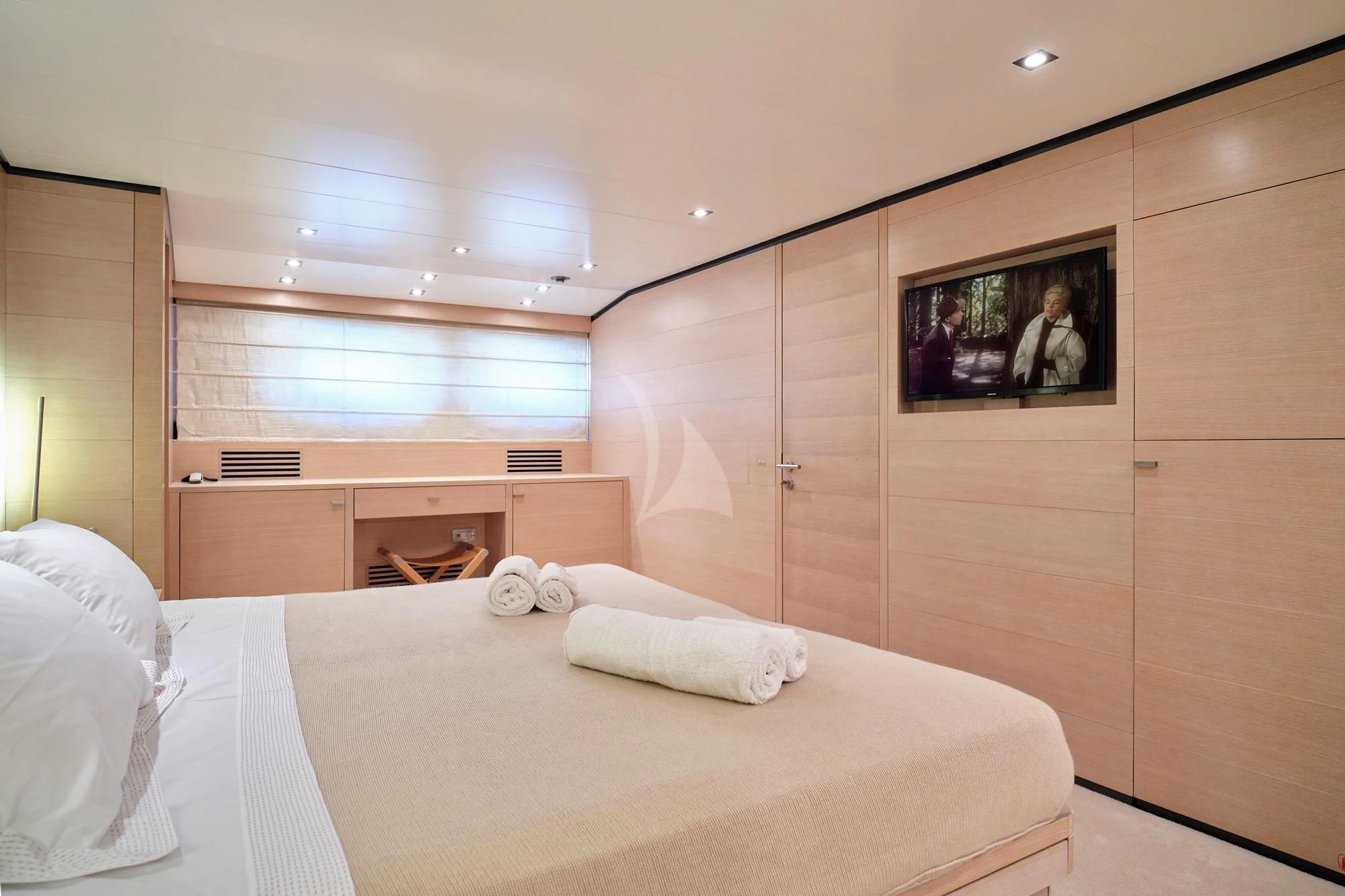 a bedroom with a bed and a television aboard AMICI PER SEMPRE Yacht for Charter