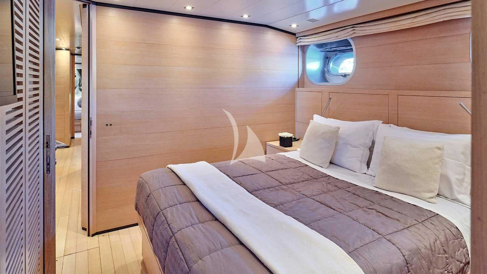 a bed with a white sheet and pillows aboard AMICI PER SEMPRE Yacht for Charter