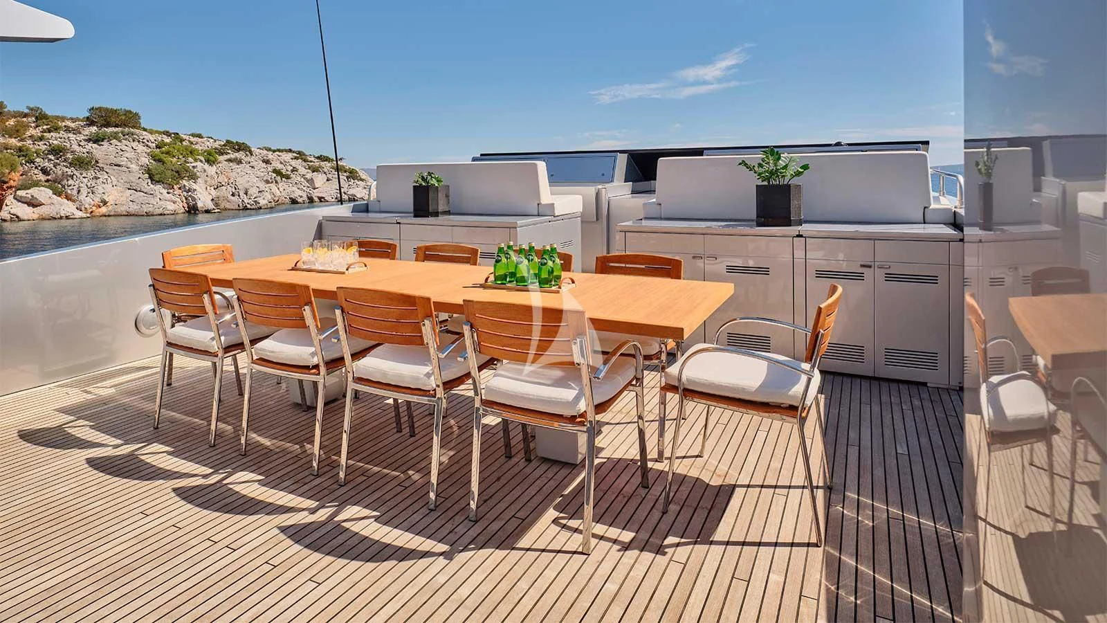 a table and chairs on a patio aboard AMICI PER SEMPRE Yacht for Charter