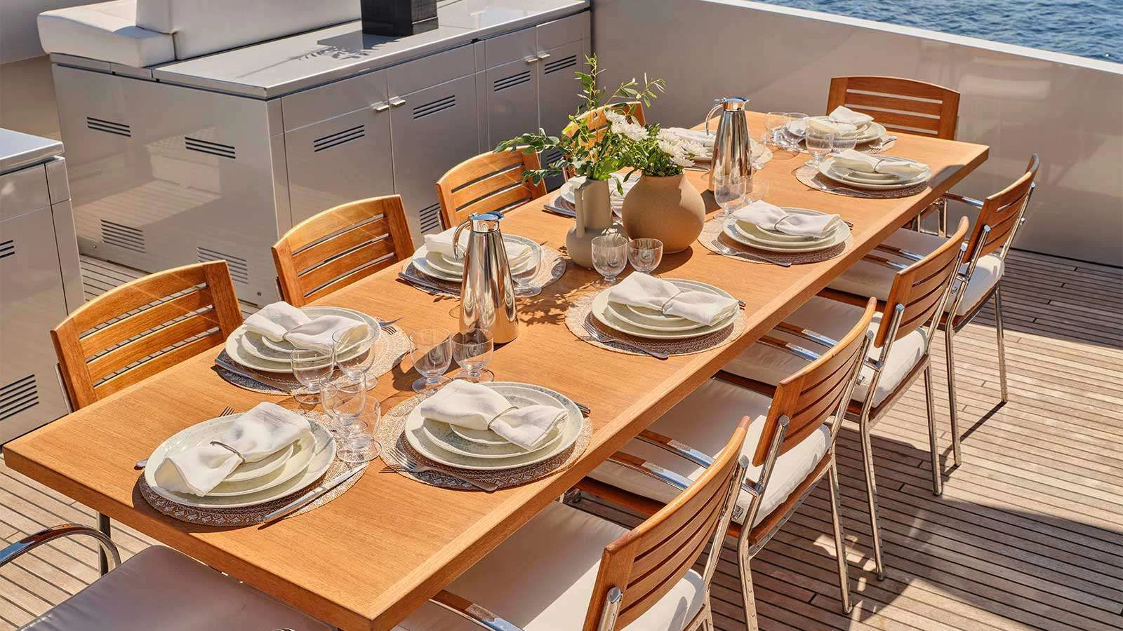 a table with plates and dishes on it aboard AMICI PER SEMPRE Yacht for Charter