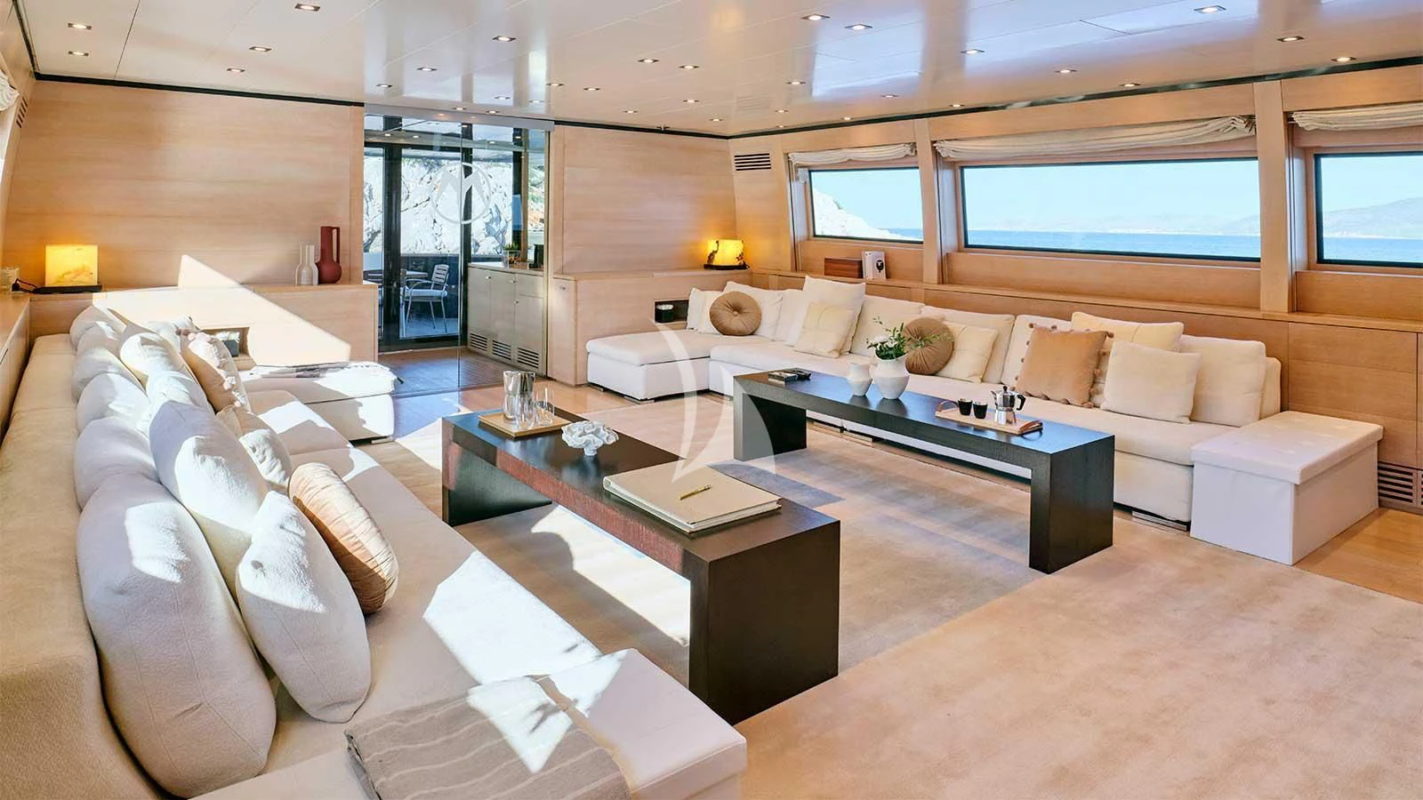 a living room with a large sofa aboard AMICI PER SEMPRE Yacht for Charter