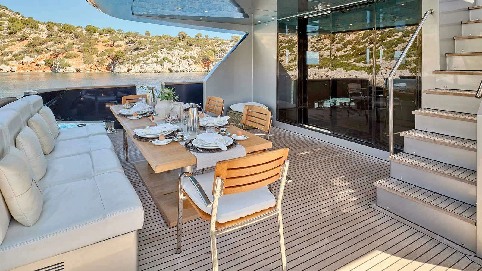 a dining table on a deck aboard AMICI PER SEMPRE Yacht for Charter