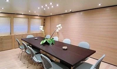 a table with chairs and a plant on it aboard AMICI PER SEMPRE Yacht for Charter