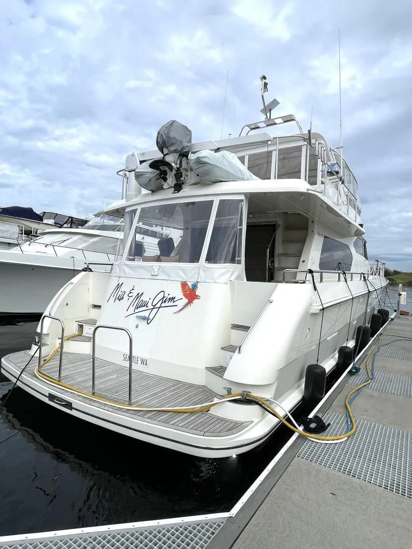 a white boat on a dock aboard MIA AND MAUI JIM Yacht for Sale