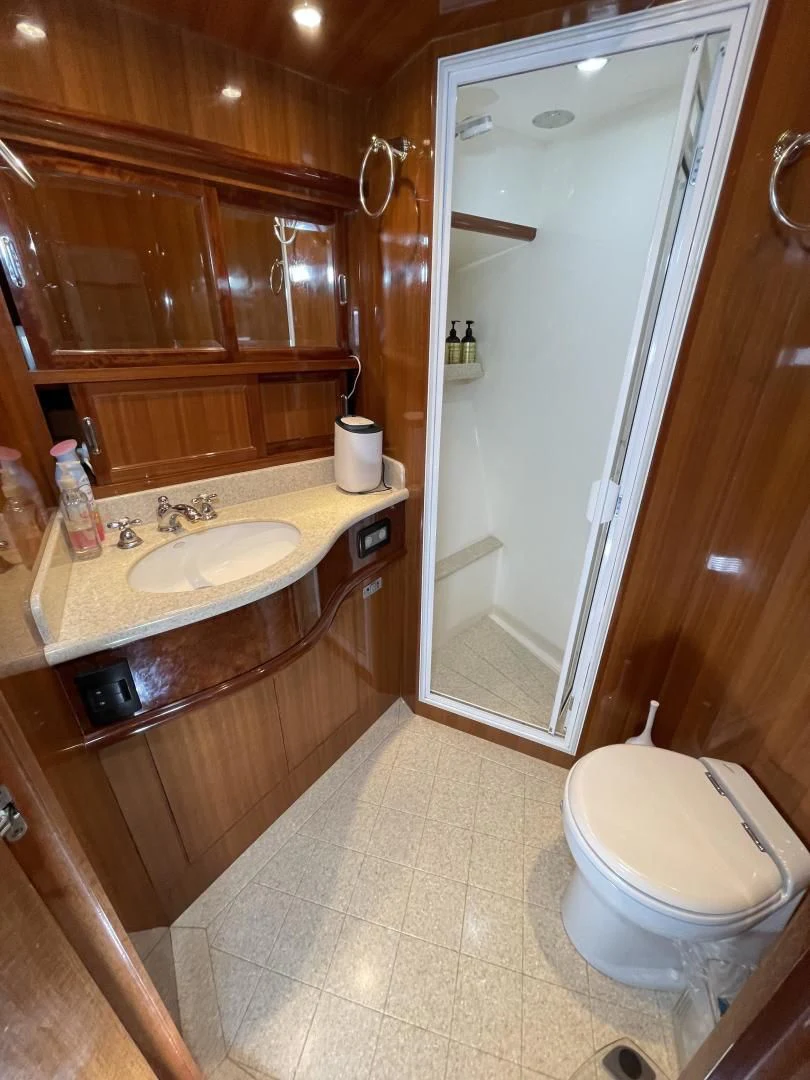 a bathroom with wooden cabinets aboard MIA AND MAUI JIM Yacht for Sale