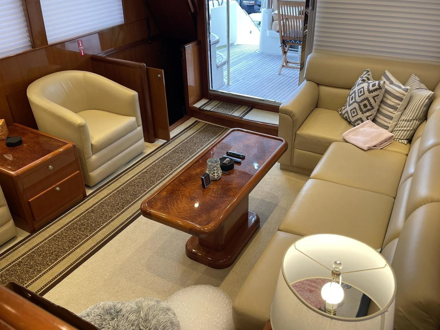 a living room with a glass coffee table and a view of the water aboard MIA AND MAUI JIM Yacht for Sale