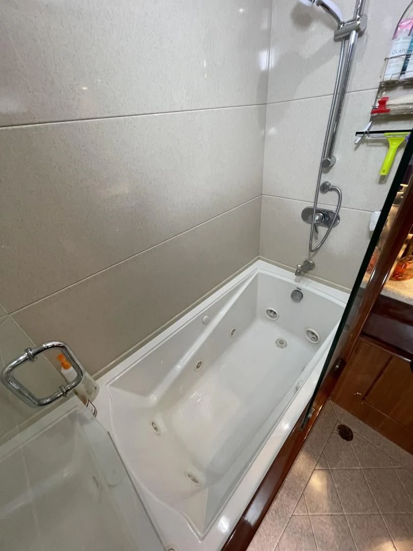 a bathtub with a shower head aboard MIA AND MAUI JIM Yacht for Sale