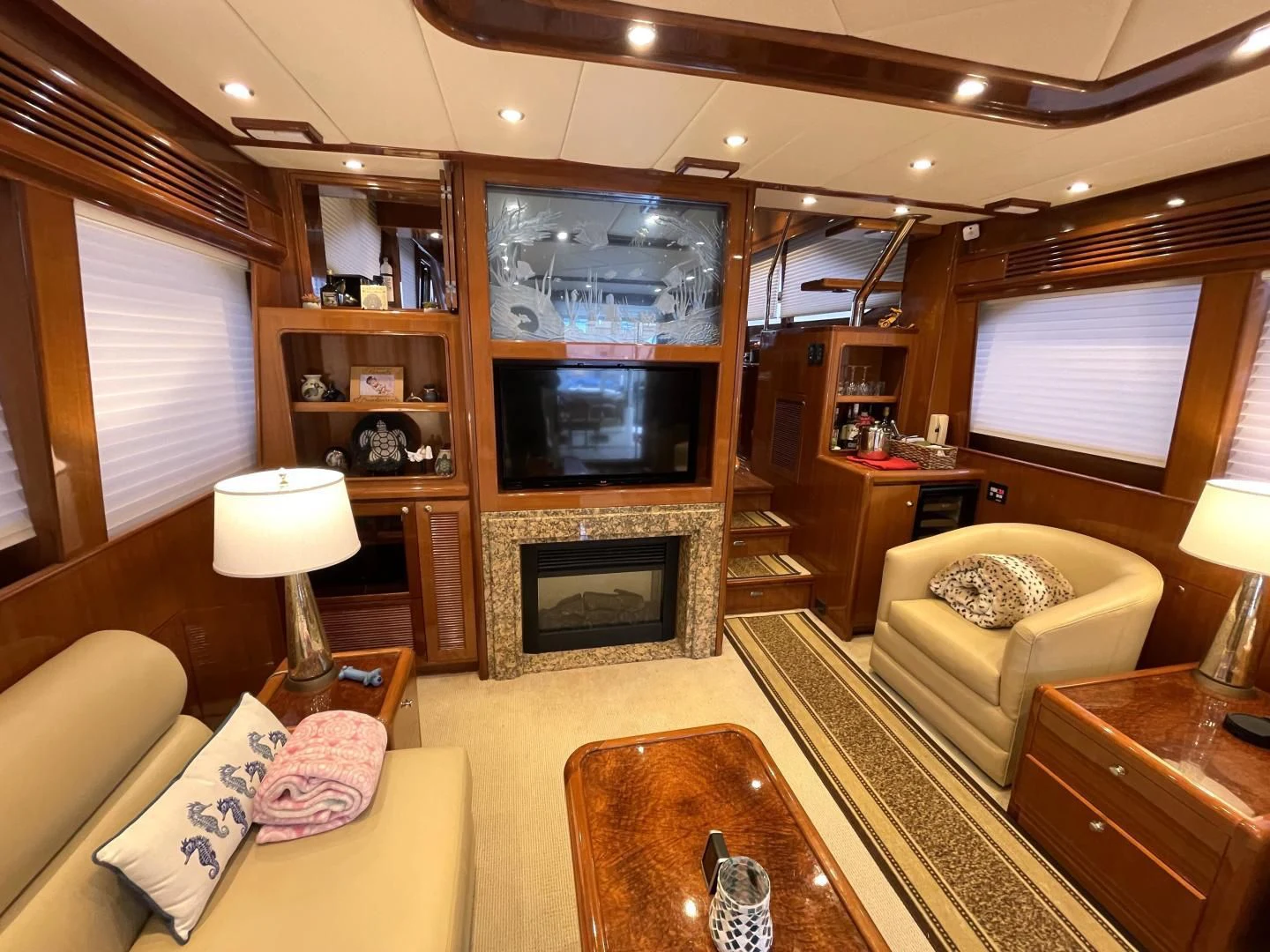 a living room with a fireplace aboard MIA AND MAUI JIM Yacht for Sale