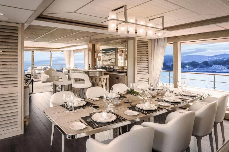 a dining room with a large window aboard CALYPSO I Yacht for Charter