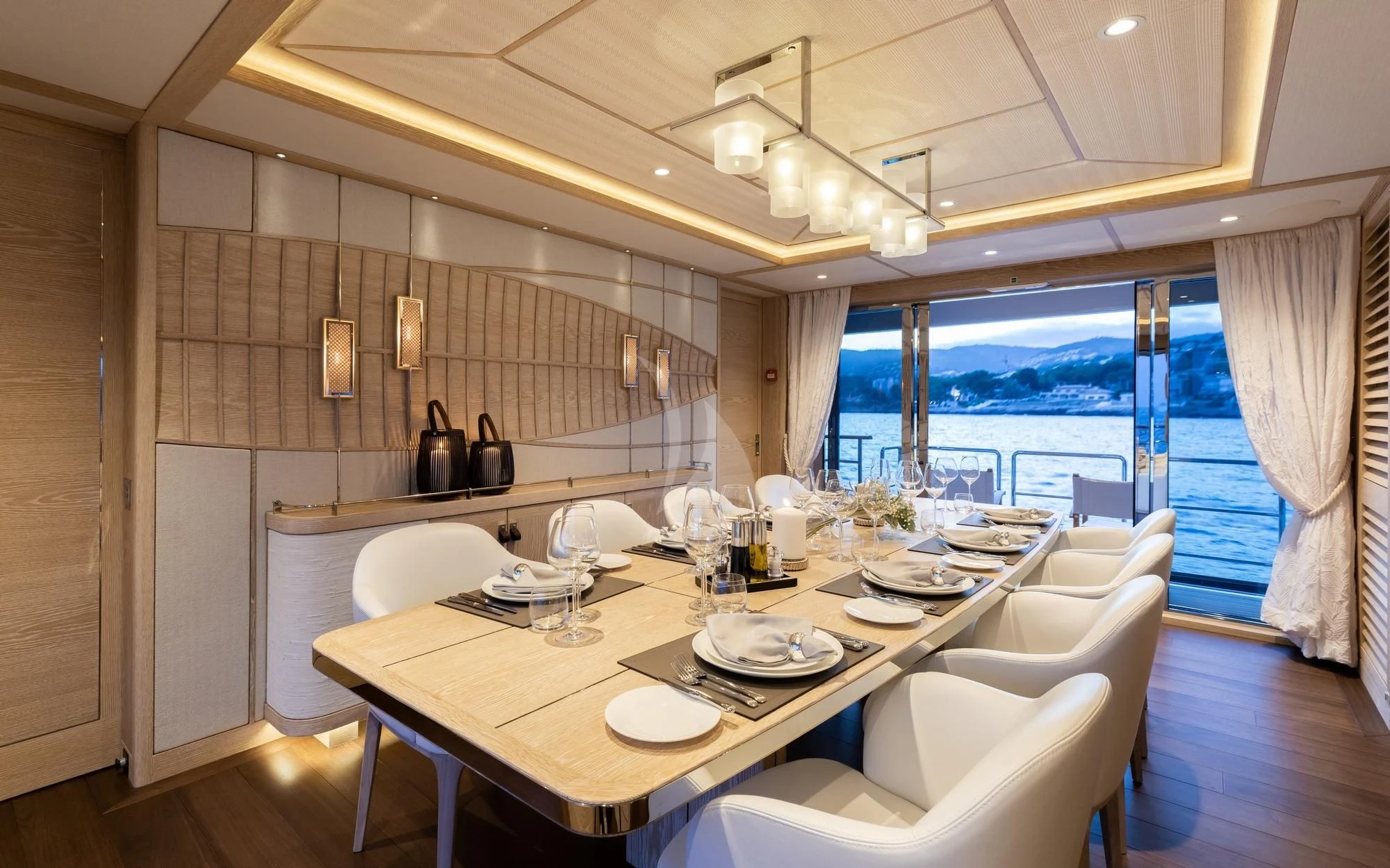 a dining table with plates and chairs aboard CALYPSO I Yacht for Charter