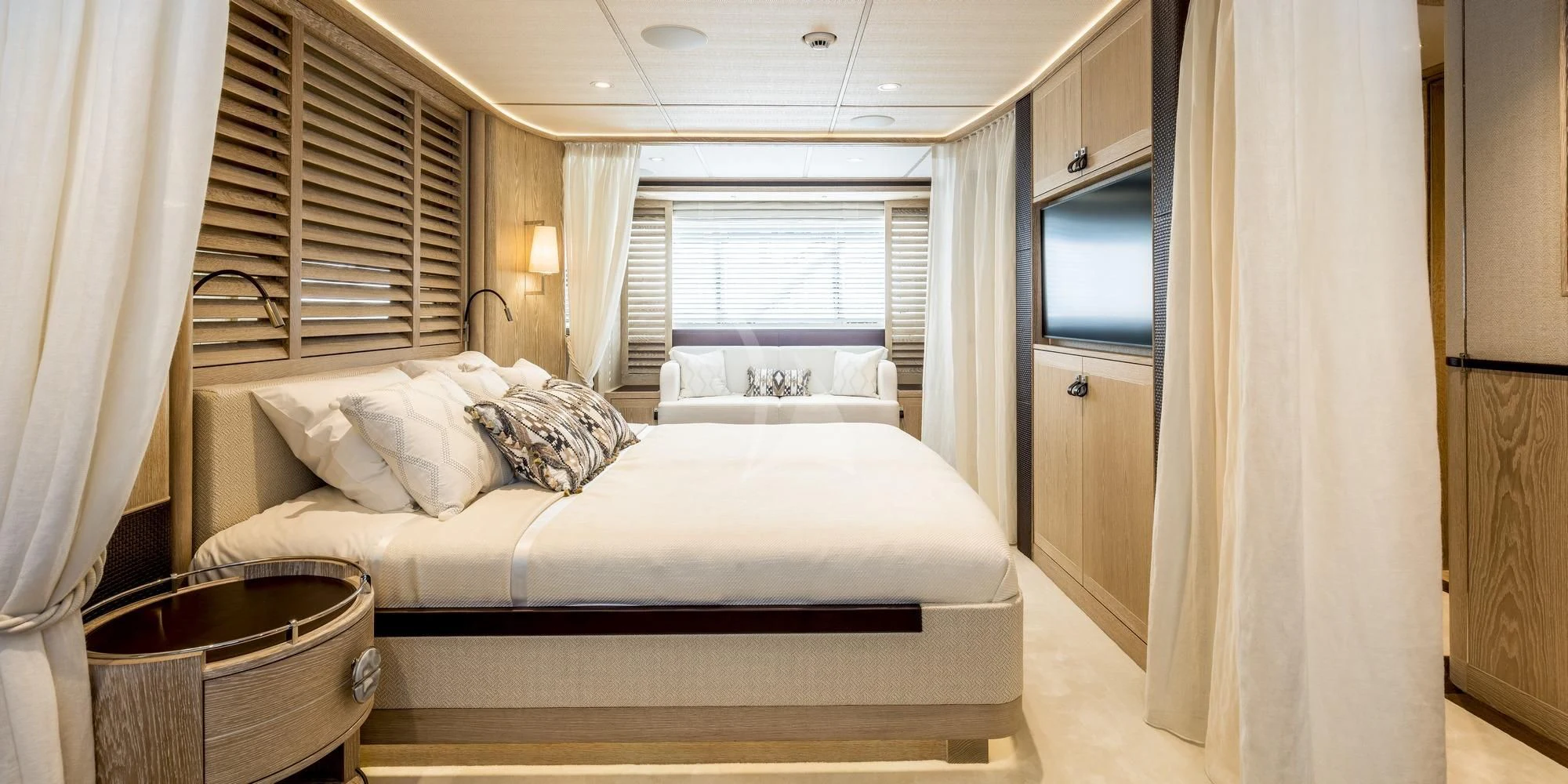 a bedroom with a bed and a television aboard CALYPSO I Yacht for Charter