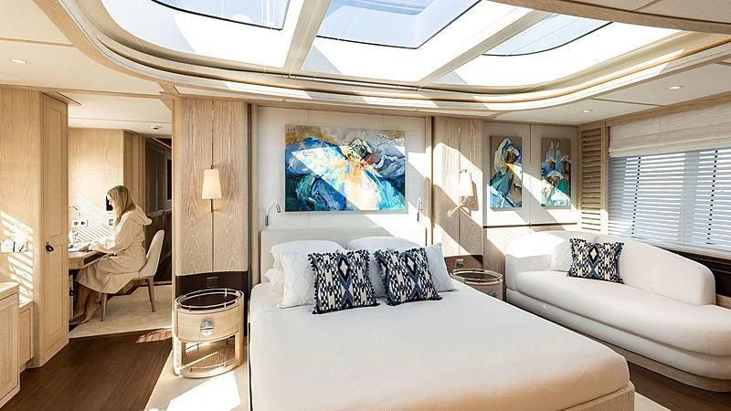 a room with a couch and a person sitting in it aboard CALYPSO I Yacht for Charter
