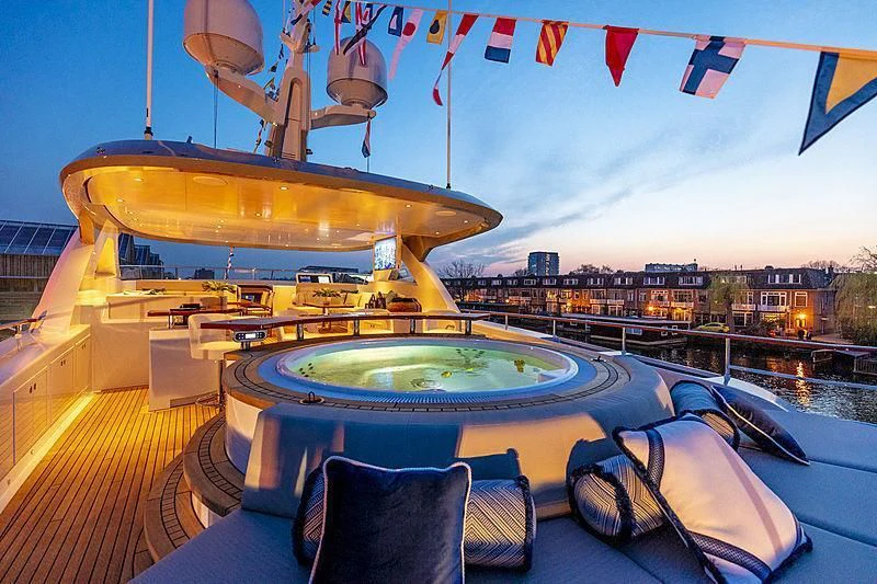 a large round pool with a yellow dome and flags on the roof aboard CALYPSO I Yacht for Charter