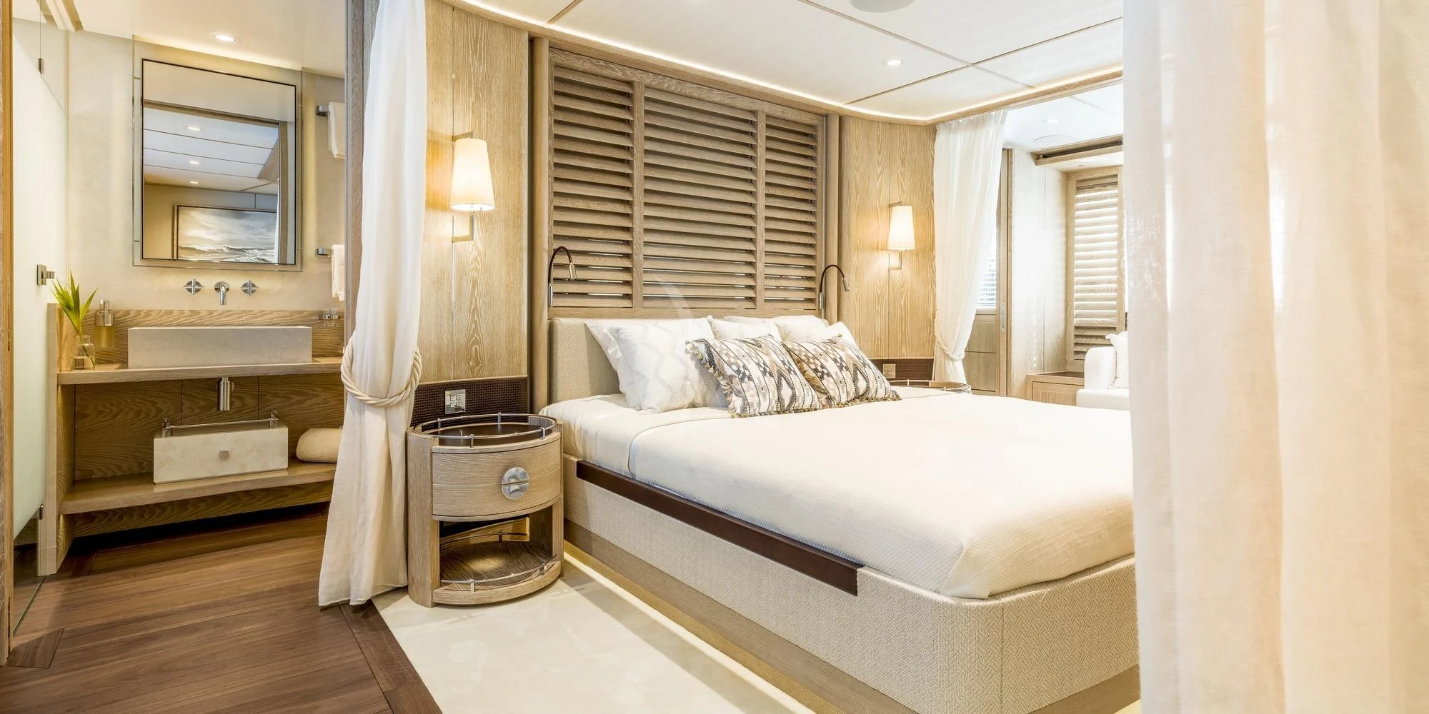 a bedroom with a bed and a mirror aboard CALYPSO I Yacht for Charter