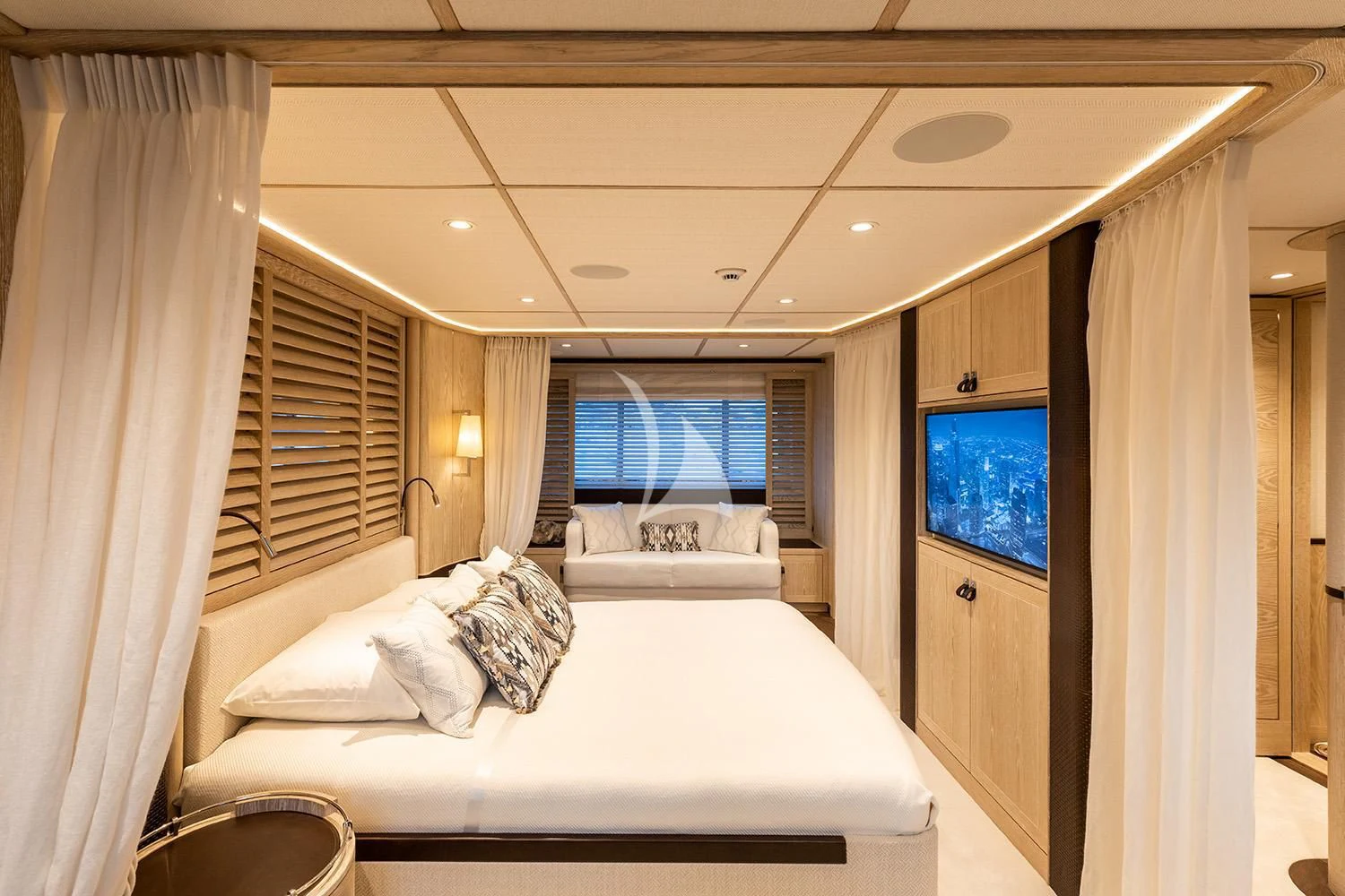 a room with a bed and a tv on the wall aboard CALYPSO I Yacht for Charter