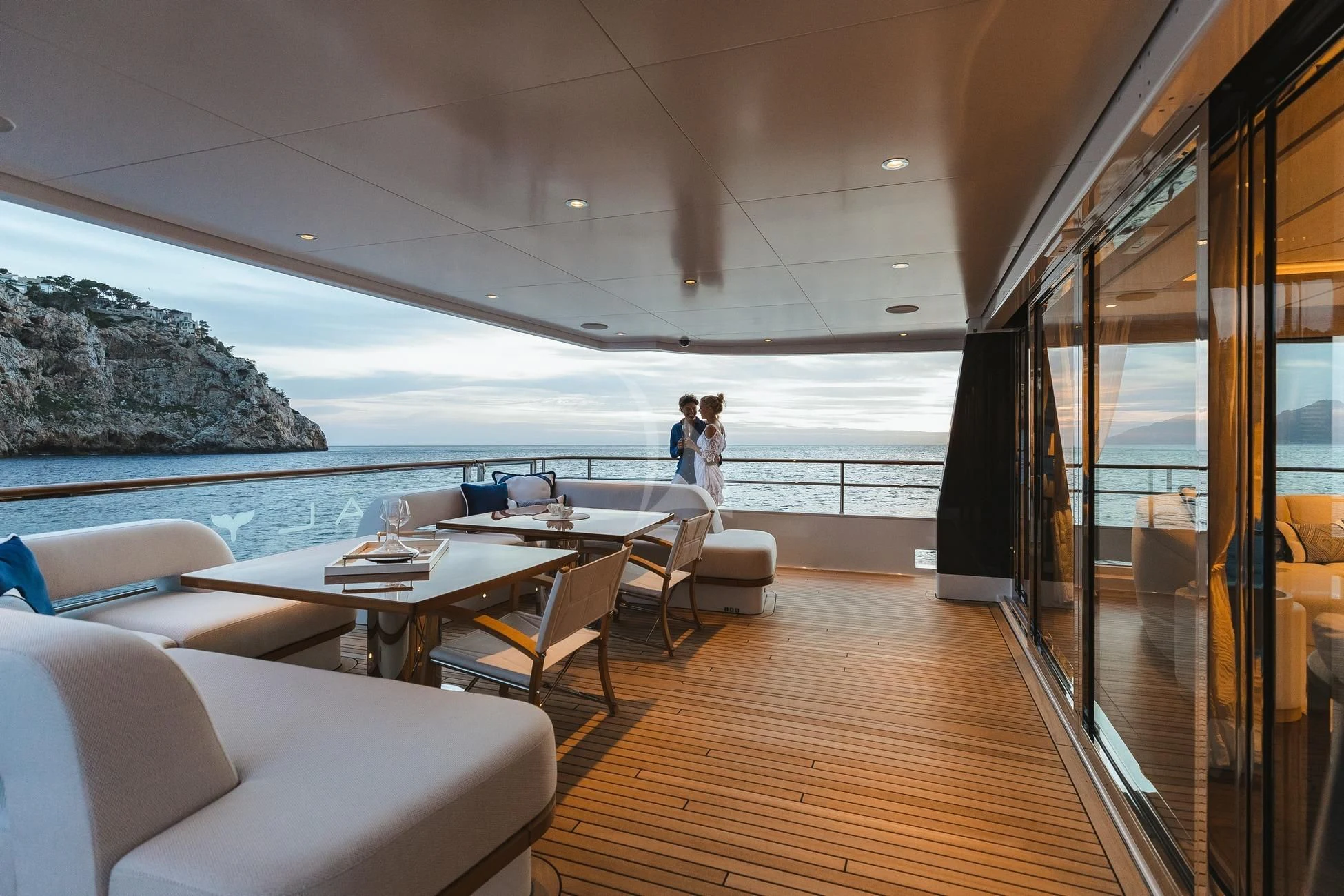 a room with a view of the ocean and a couple of people aboard CALYPSO I Yacht for Charter