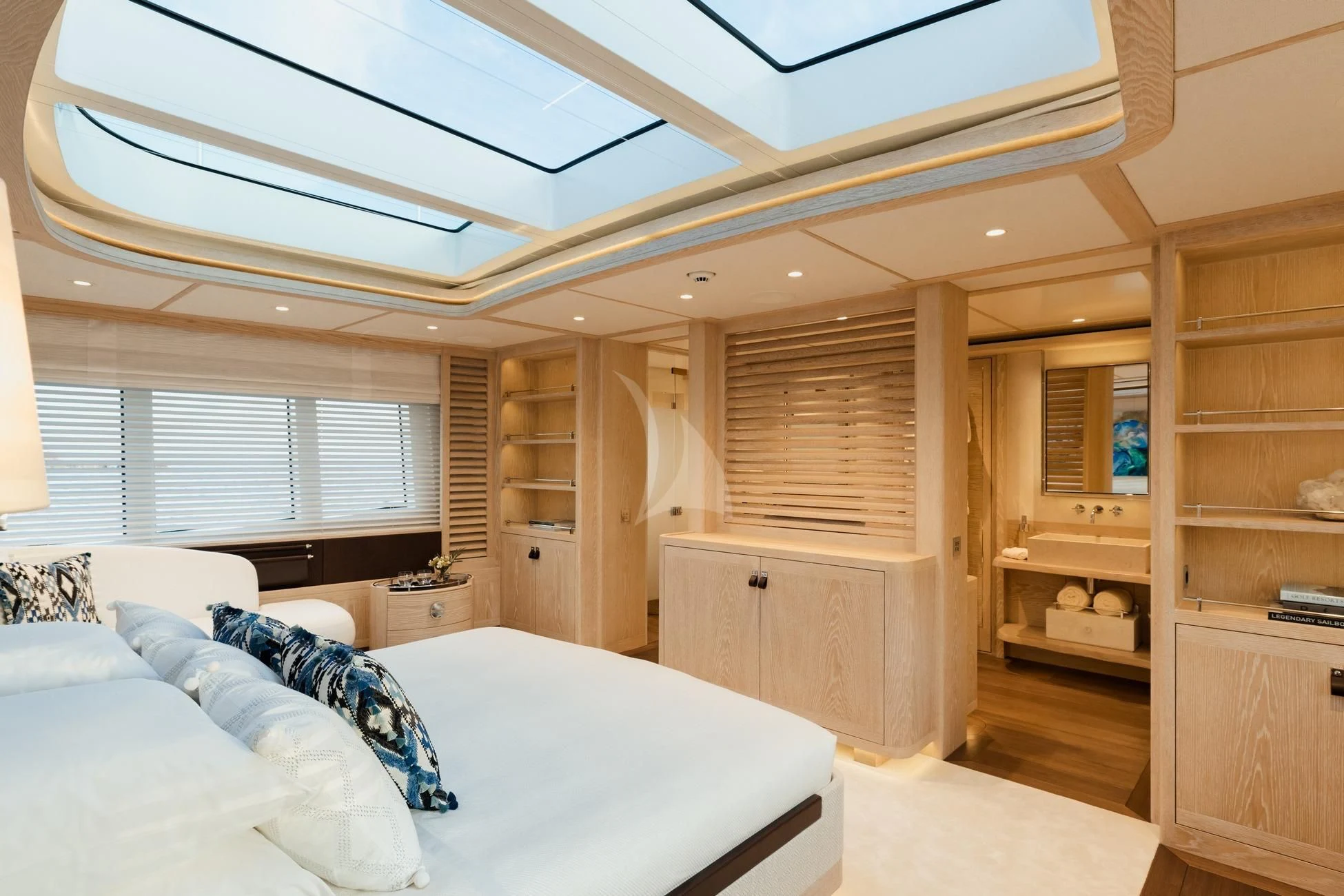 a bedroom with a bed and a bookcase aboard CALYPSO I Yacht for Charter