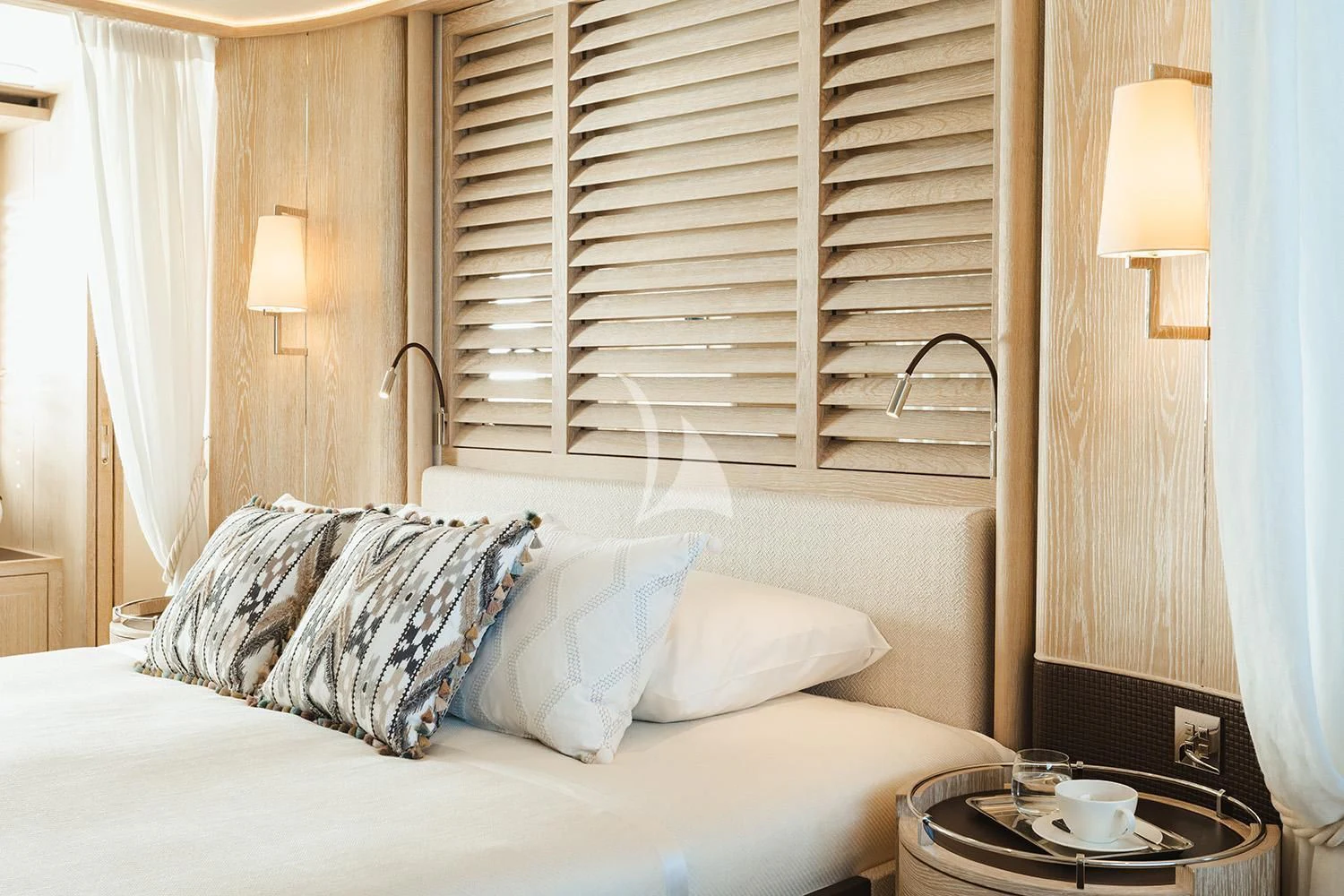 a bed with white sheets aboard CALYPSO I Yacht for Charter