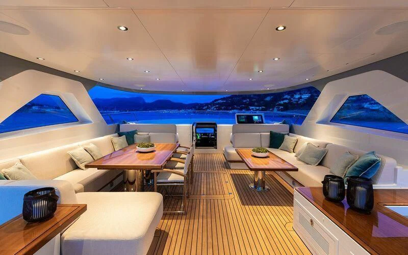 a room with a couch and a table and a pool aboard CALYPSO I Yacht for Charter