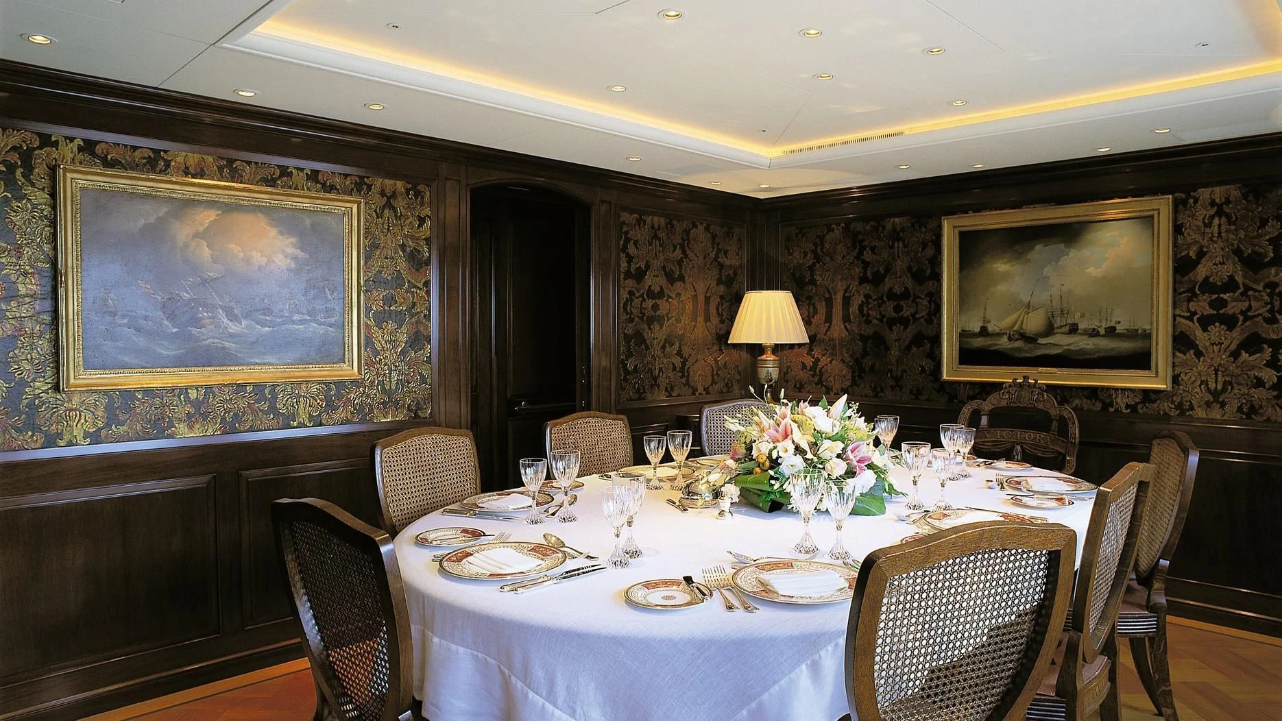 a dining room with a table set for a formal dinner aboard ROCK & ROLL Yacht for Sale