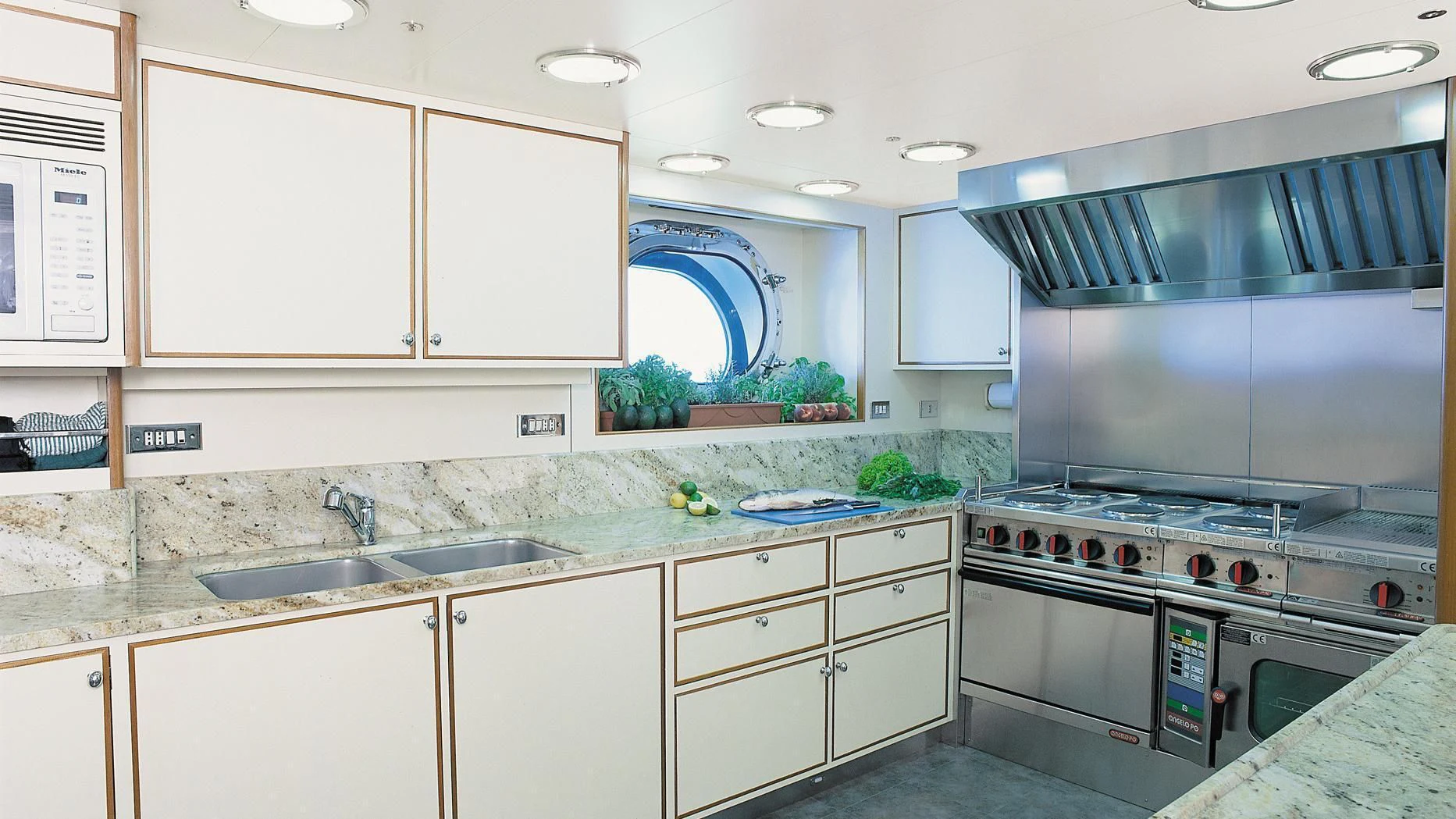 a kitchen with white cabinets aboard ROCK & ROLL Yacht for Sale