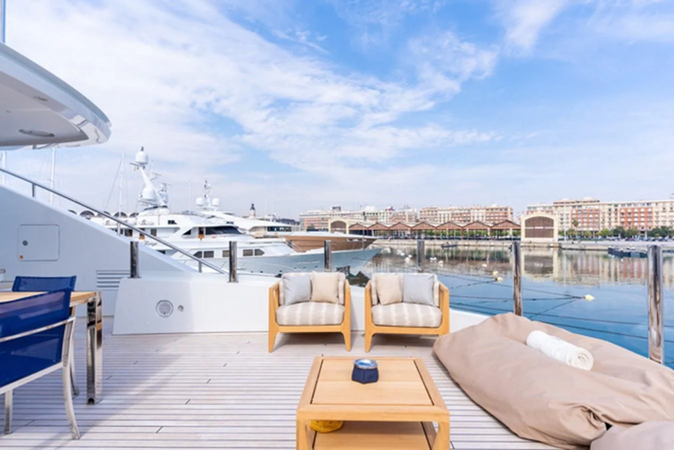a deck with chairs and a table on it aboard ALI BABA Yacht for Sale