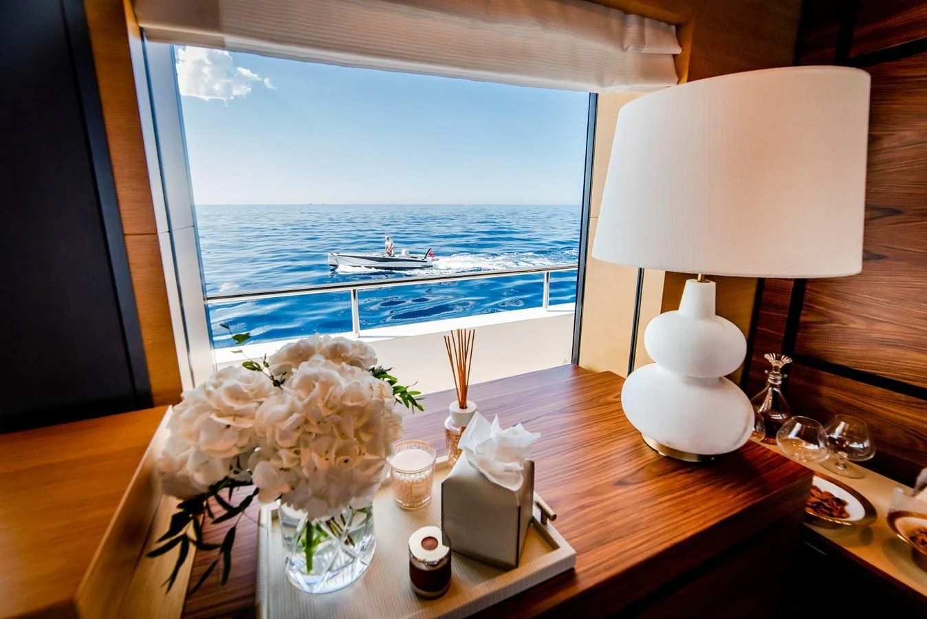 a table with flowers and candles on it aboard ALI BABA Yacht for Sale