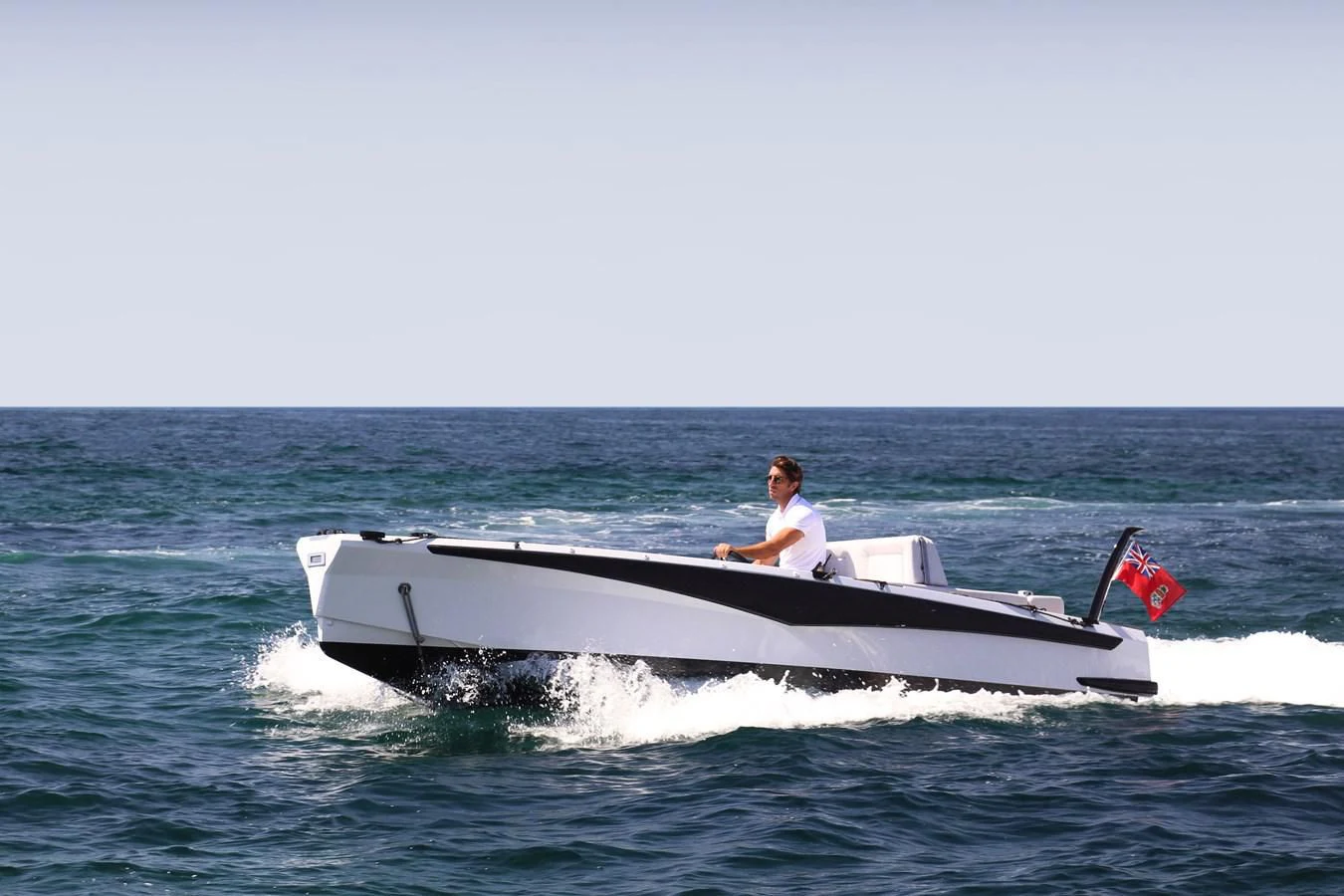 a man driving a speedboat aboard ALI BABA Yacht for Sale