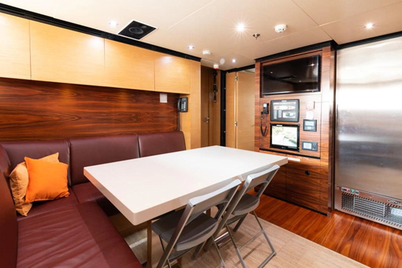 a room with a table and chairs aboard ALI BABA Yacht for Sale