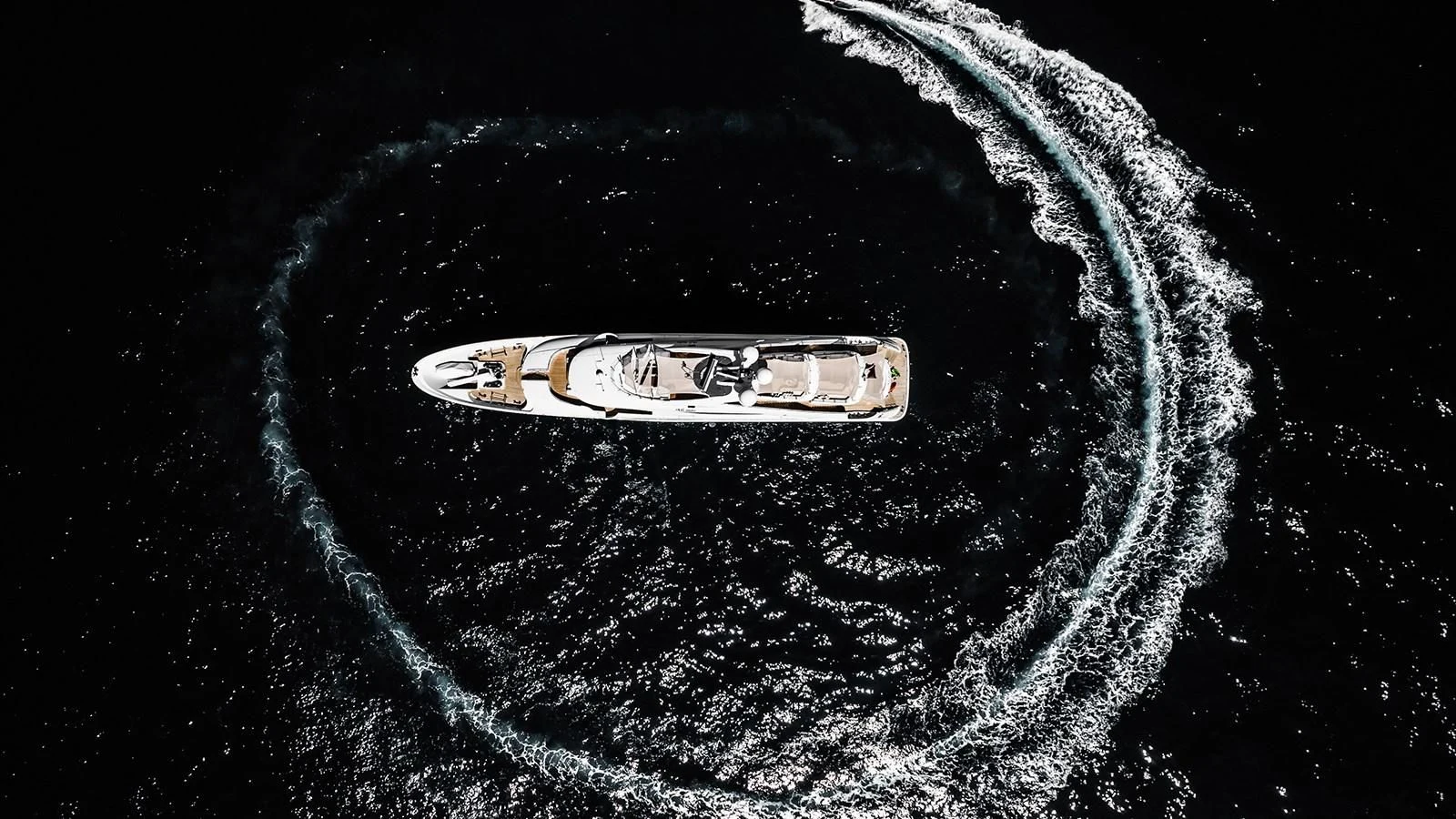 a gold ring on a black background aboard ALI BABA Yacht for Sale