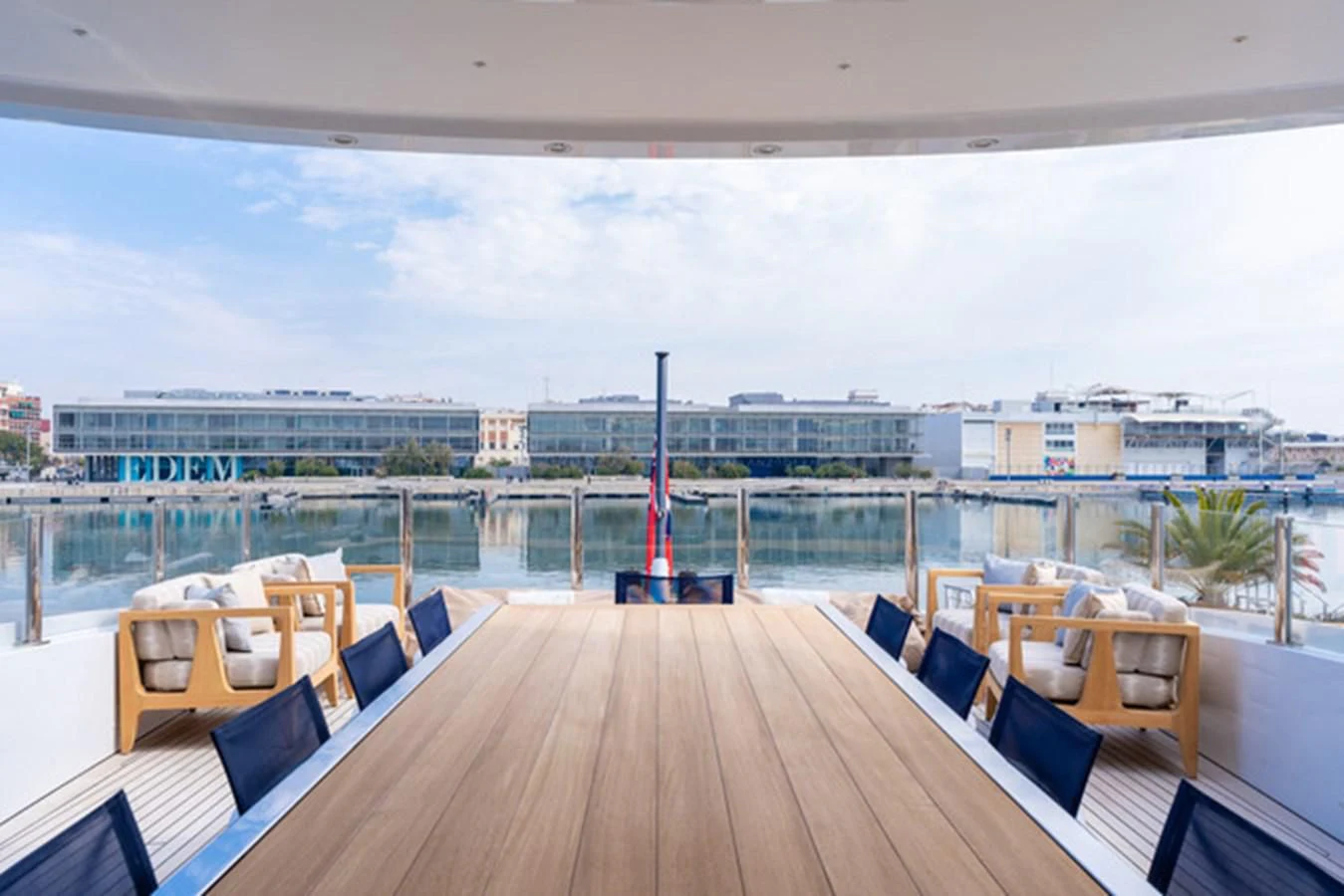a deck with a view of a city and a body of water aboard ALI BABA Yacht for Sale