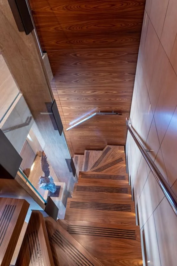 a wooden staircase with a railing aboard ALI BABA Yacht for Sale