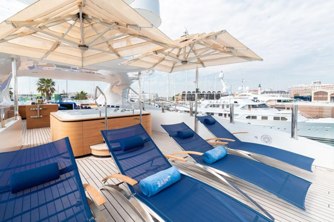 a deck with a pool and a view of the city aboard ALI BABA Yacht for Sale