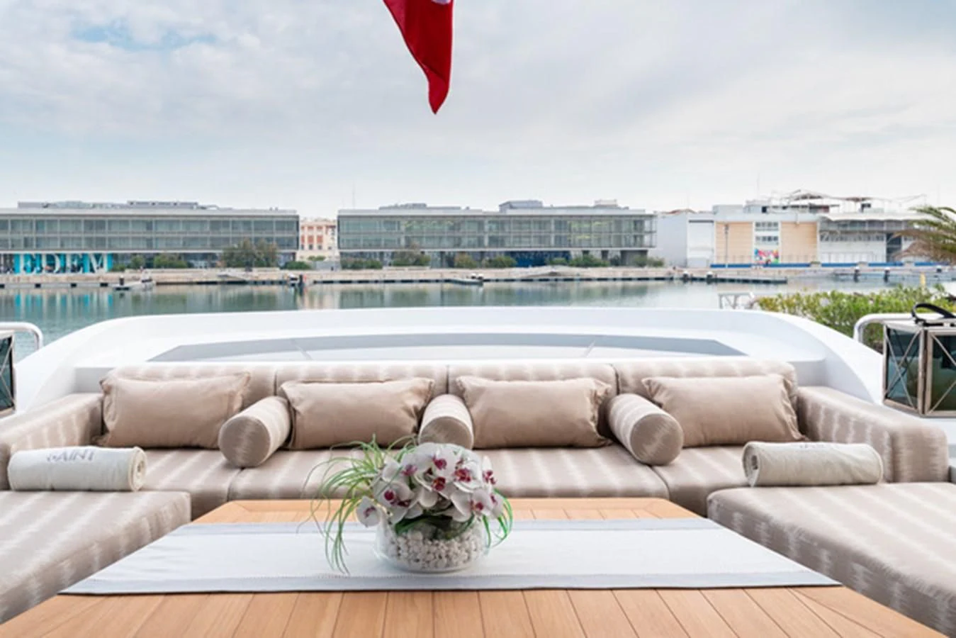 a couch and a vase on a table by a pool aboard ALI BABA Yacht for Sale