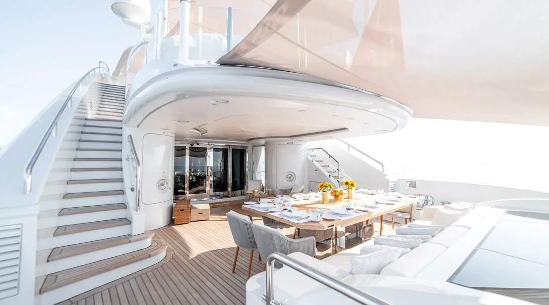 a room with a table and chairs aboard ALI BABA Yacht for Sale