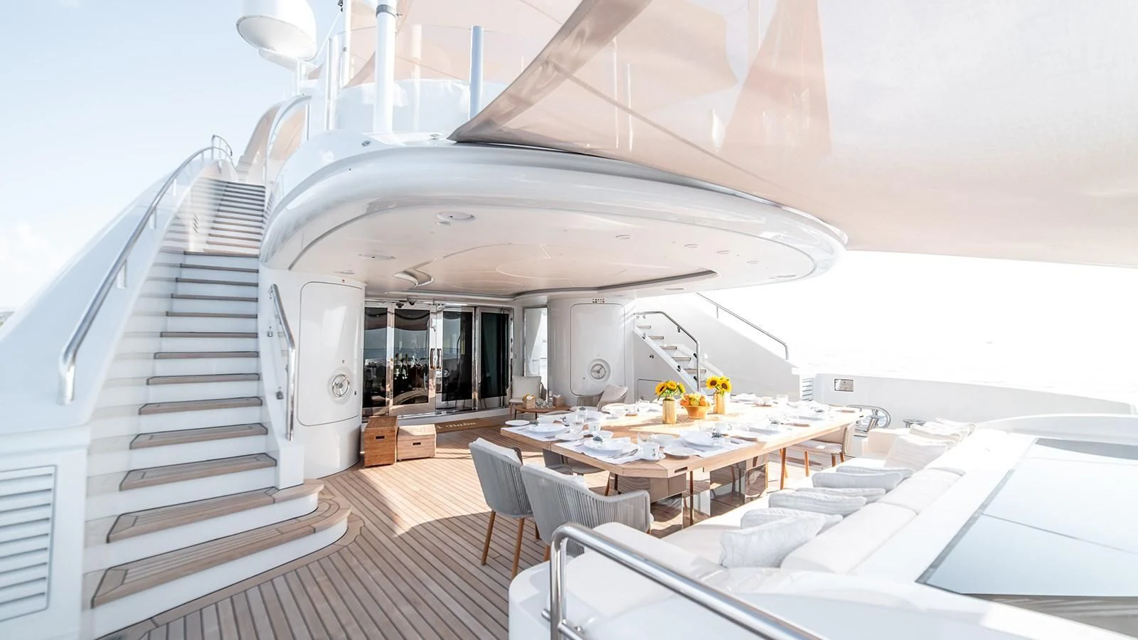 a room with a table chairs and a large white building aboard ALI BABA Yacht for Sale