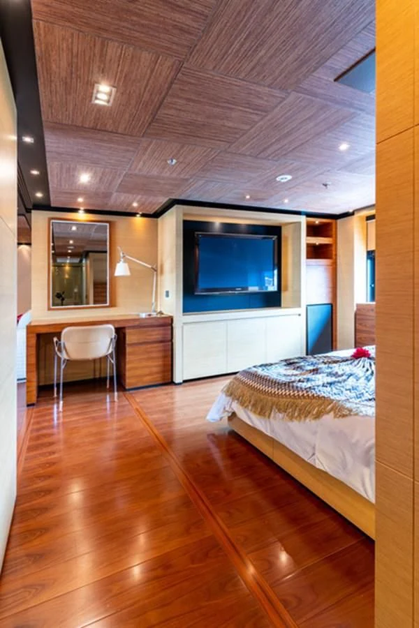 a bedroom with a bed and a tv aboard ALI BABA Yacht for Sale