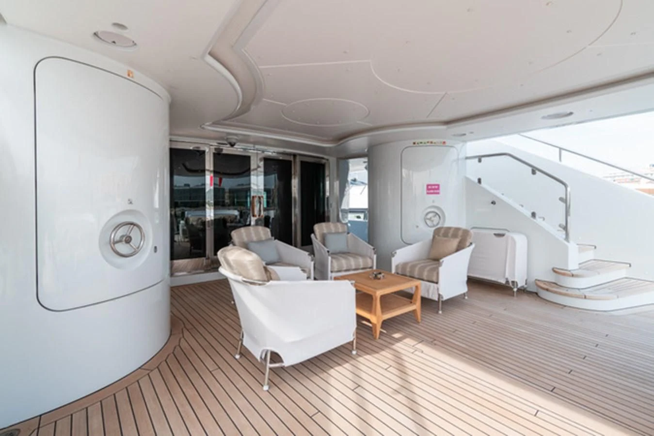 a room with a large mirror and a table and chairs aboard ALI BABA Yacht for Sale