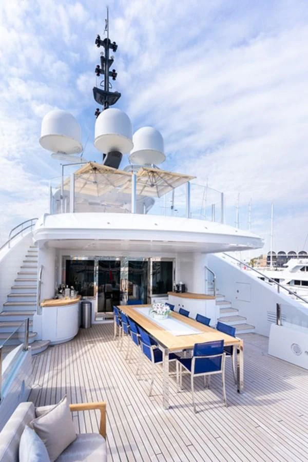 a table and chairs on a deck aboard ALI BABA Yacht for Sale