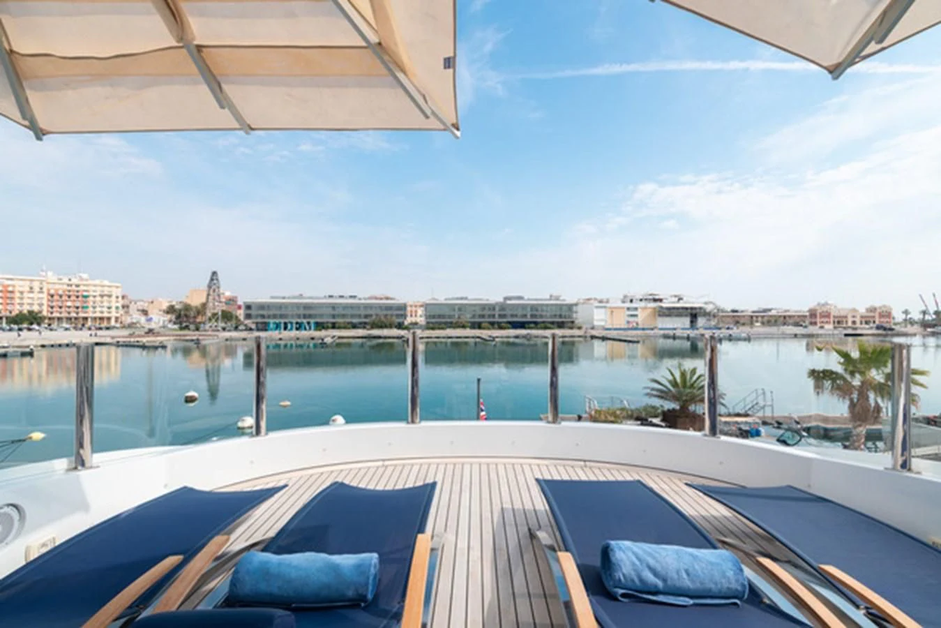 a deck with a view of a city and water aboard ALI BABA Yacht for Sale
