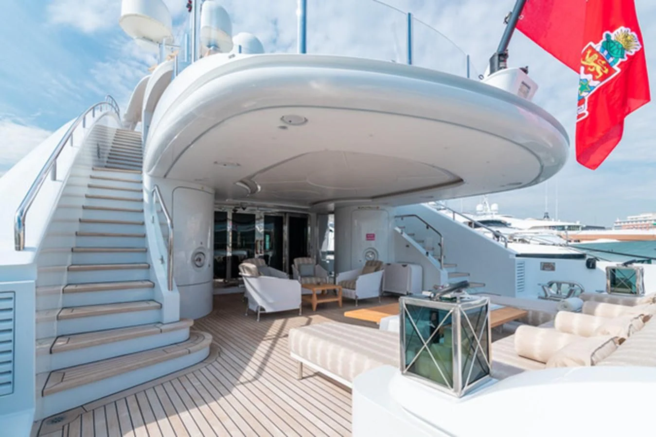 a large white building with a staircase and chairs aboard ALI BABA Yacht for Sale