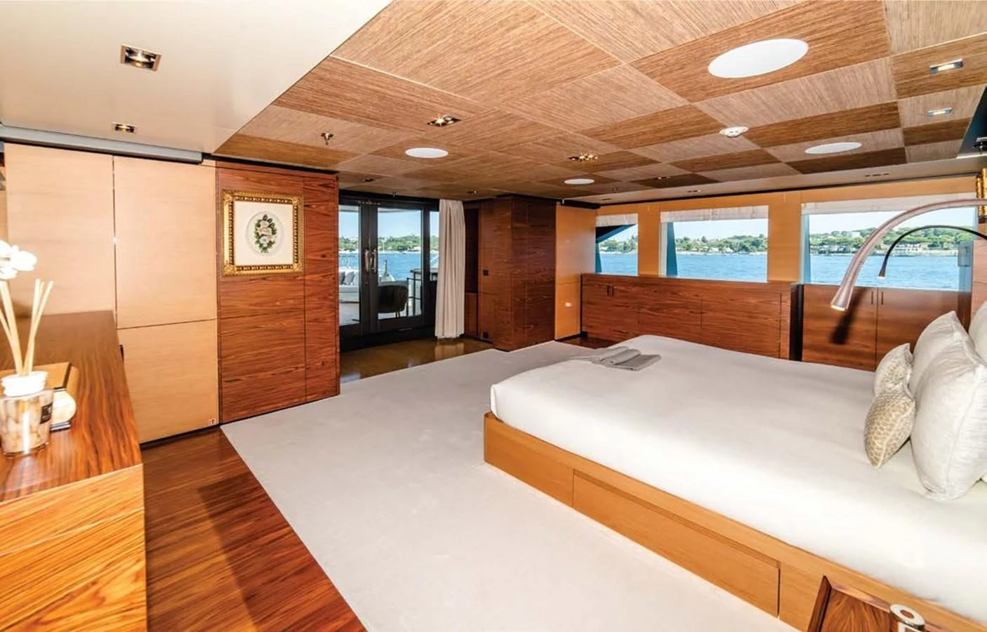 a large living room with a large couch and a wood table aboard ALI BABA Yacht for Sale