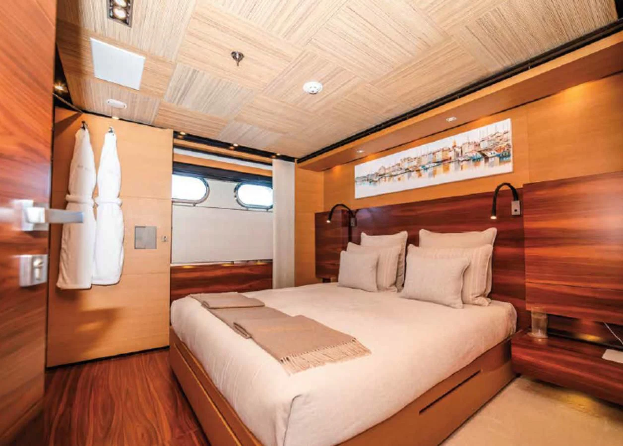 a room with a bed and a wood wall aboard ALI BABA Yacht for Sale