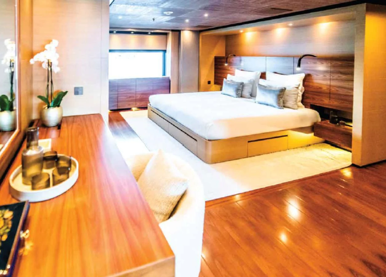 a room with a bed and a table aboard ALI BABA Yacht for Sale