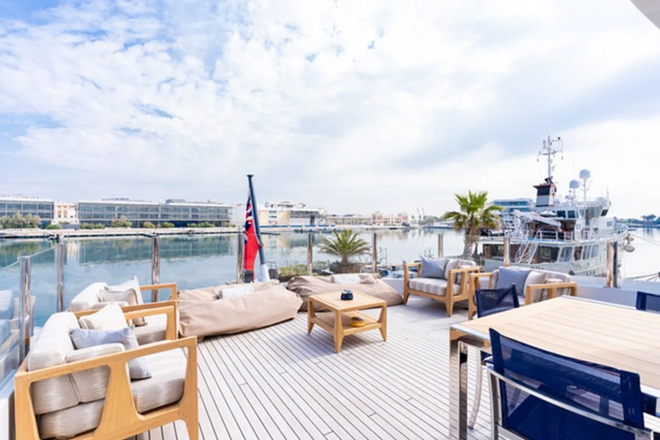 a deck with chairs and tables on it aboard ALI BABA Yacht for Sale