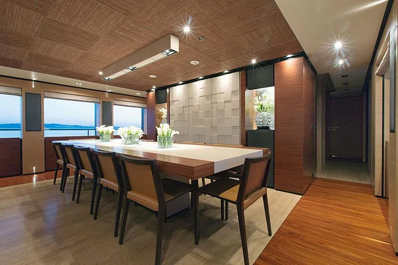 a large dining table in a room aboard ALI BABA Yacht for Sale