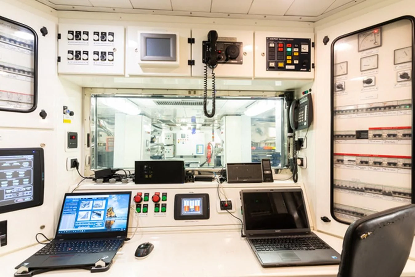 a room with computers and monitors aboard ALI BABA Yacht for Sale
