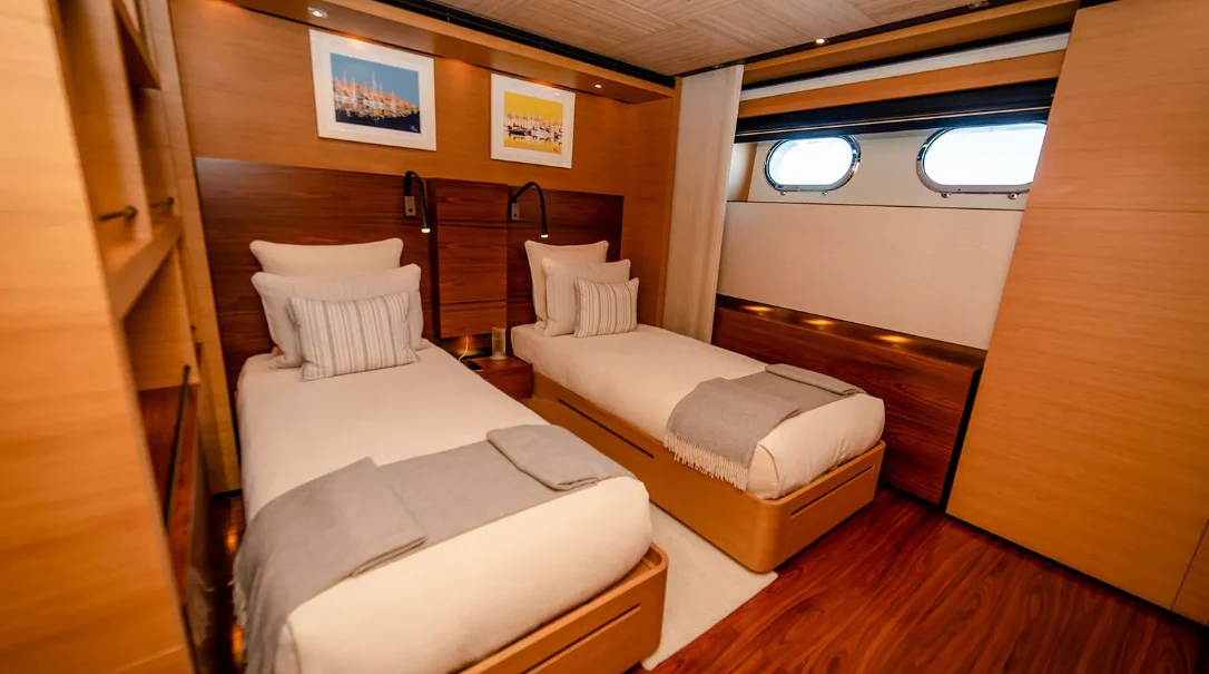 a room with beds and a window aboard ALI BABA Yacht for Sale